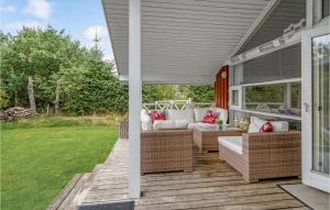 a screened in porch with a couch on a house at Nice Home In Lkken With Indoor Swimming Pool in Trudslev