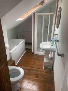 a bathroom with a toilet and a sink at 2-bedroom cottage in heart of St Ives w/ parking in St Ives