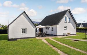 a white house with a black roof at 5 Bedroom Amazing Home In Strandby in Strandby