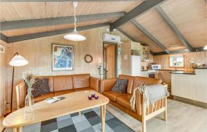 a living room with a couch and a table at Amazing Home In Hvide Sande With Wifi in Bjerregård