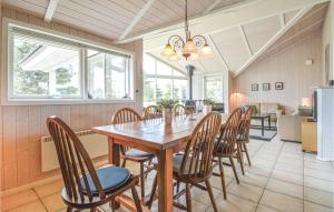 a dining room with a wooden table and chairs at Holiday Home Gl Mælkevej Xii in Blåvand