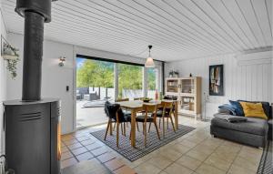 a kitchen and living room with a table and chairs at Amazing Home In Blåvand With Kitchen in Ho