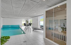 a room with a swimming pool and a dining room at Amazing Home In Blåvand With Kitchen in Ho +21 photos