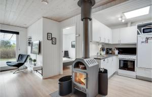 a kitchen with a stove in the middle of a room at Stunning Home In Blvand With 3 Bedrooms And Wifi in Blåvand