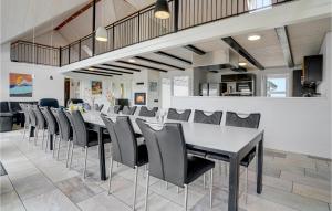 a dining room with a long table and chairs at Beautiful Home In Harboøre With Sauna in Harboør