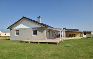 a house with a wooden deck in the yard at Awesome Home In Harboøre With Kitchen in Harboør