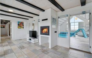 a living room with a fireplace and a slide at Beautiful Home In Harboøre With Sauna in Harboør