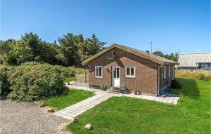 a small brick house with a grass yard at Holiday Home Clemmessti in Klitmøller +18 photos