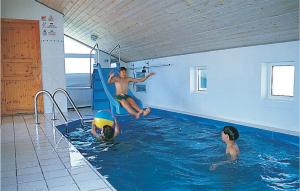 a group of people in a swimming pool at Nice Home In Thisted With Indoor Swimming Pool in Klitmøller