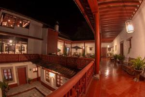 a large building with a bar and a balcony at Hotel Boutique Posada La Basilica in Pátzcuaro