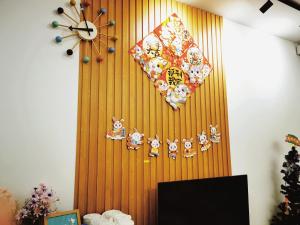 a wall with a clock and a plate on it at Aishiteru Homestay in Kuala Lumpur
