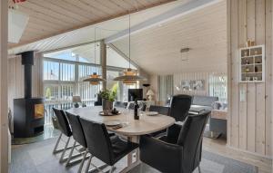 a dining room with a table and chairs at Cozy Home In Hemmet With Wifi in Falen