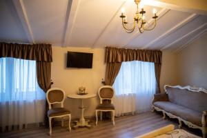 a living room with a couch and a table and chairs at Oldtownvilla studio central in Sibiu