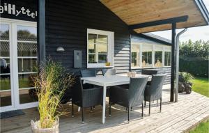 a patio with a table and chairs on a deck at Hygihytten in Hemmet +19 photos