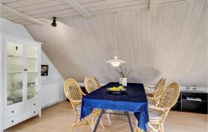 a dining room with a blue table and chairs at Stunning Apartment In Thisted With Wifi in Thisted