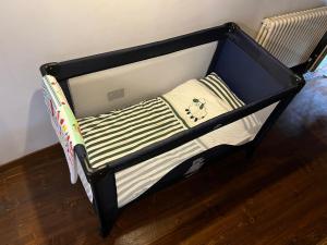 a small crib with a black frame with a bear on it at Ca’ Adele in Morbegno +4 photos