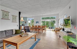 a living room with a couch and a table at Three-Bedroom Holiday Home In Spottrup in Spottrup