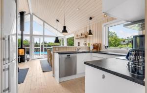 a kitchen with white cabinets and a large window at Gorgeous Home In Vemb in Vemb +20 photos