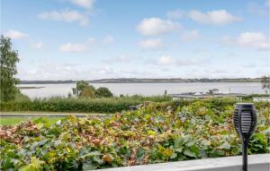 a garden with a view of a body of water at Amazing Home In Roslev With Wifi in Roslev +17 photos
