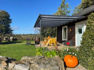 a house with a porch with a swing and a pumpkin at The Old Rectory Donard in Dún Ard