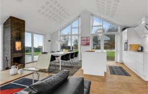 a kitchen and living room with a table and chairs at 3 Bedroom Cozy Home In Haderslev in Kelstrup Strand