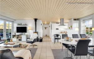 a living room with a table and chairs at Amazing Home In Ulfborg With Kitchen in Øhuse