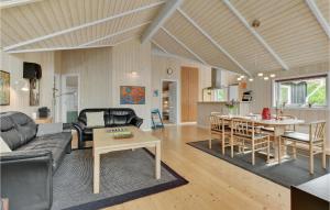 a living room with a couch and a table at Holiday Home Lindevej Broager Ix in Broager +22 photos