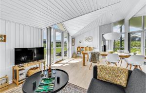 a living room with a couch and a table at Beautiful Home In Ringkbing With 3 Bedrooms, Sauna And Wifi in Søndervig