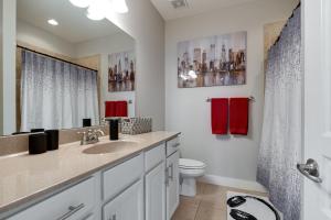 a bathroom with a sink and a toilet and red towels at Music Row Nashville King Beds Keyless Entry in Nashville