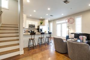 a living room with a couch and a kitchen at Music Row Nashville King Beds Keyless Entry in Nashville