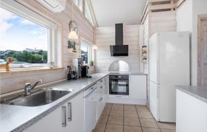a kitchen with a sink and a refrigerator at Holiday Home Anemonevej Sjølund I in Hejls