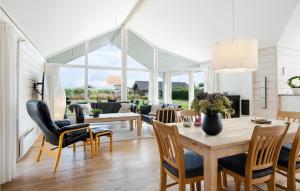 a living room with a table and chairs at Holiday Home Anemonevej Sjølund I in Hejls