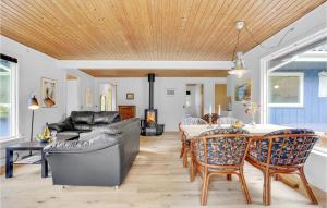 a living room with a table and chairs and a couch at Two-Bedroom Holiday Home In Herning in Herning