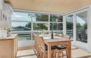 a dining room with a table and chairs at Nice Home In Hejls With 4 Bedrooms And Wifi in Hejls