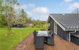a patio with a table and chairs on a deck at Holiday Home Give 37 in Lindet +17 photos