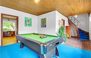 a room with a pool table and a staircase at Hellehave in Ravnholt