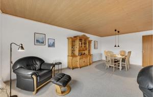a living room with leather chairs and a table at 3 Bedroom Lovely Home In Ulfborg in Ulfborg