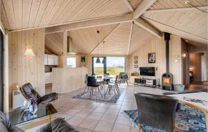 Lild StrandにあるStunning Home In Frstrup With 4 Bedrooms, Sauna And Wifiの広いリビングルーム(テーブル、椅子付)