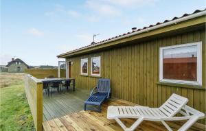 een houten terras met 2 stoelen en een tafel bij Amazing Home In Harbore With House A Panoramic View in Harboør