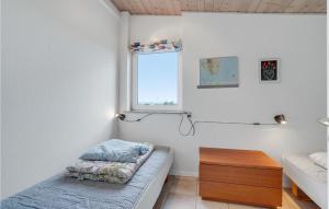 a bedroom with a bed and a window at Amazing Home In Ebeltoft With 2 Bedrooms And Wifi in Ebeltoft