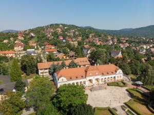 an aerial view of a large building in a town at Teleki-Wattay Kastélyszálló in Pomáz