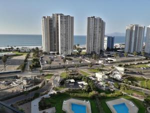 an aerial view of a city with tall buildings and the ocean at Marina Costa in Coquimbo