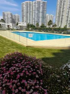 a swimming pool in a city with tall buildings at Marina Costa in Coquimbo +2 photos