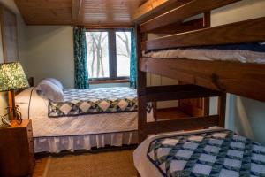 a bedroom with two bunk beds and a window at The Pelton House in New Buffalo