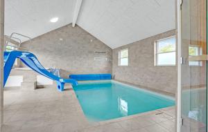 a swimming pool with a slide in a house at Nice Home In Sydals With 7 Bedrooms, Sauna And Wifi in Høruphav