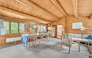 a dining room with a table and chairs at Four-Bedroom Holiday Home In Otterup in Otterup