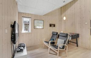 a room with a desk and chairs in a room at 7 Bedroom Cozy Home In Sydals in Høruphav