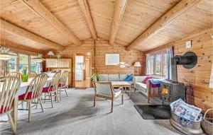 a living room with a couch and a table and chairs at Four-Bedroom Holiday Home In Otterup in Otterup