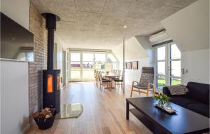a living room with a fireplace and a table at Beautiful Home In Otterup With Kitchen in Tørresø