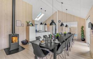 a dining room with a table and a fireplace at 7 Bedroom Cozy Home In Sydals in Høruphav